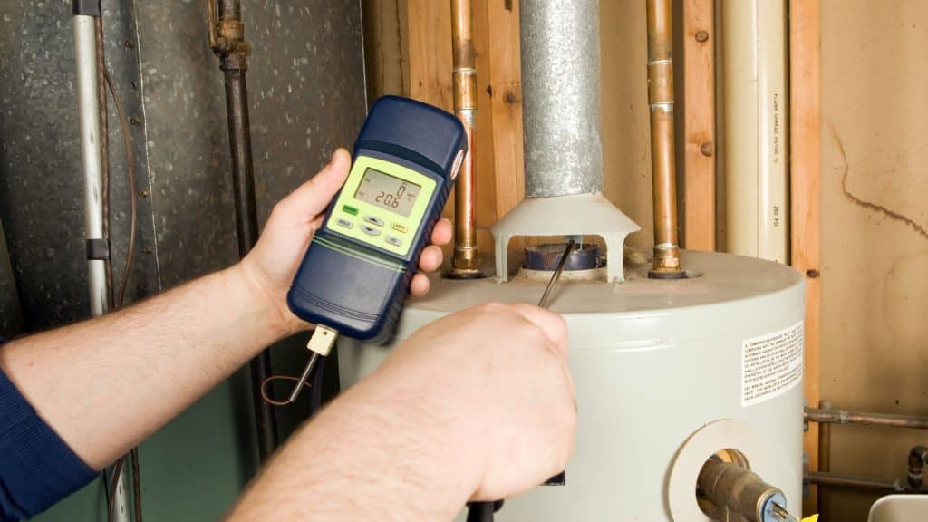 a HVAC technician checkin CO in the boiler of a HVAC system