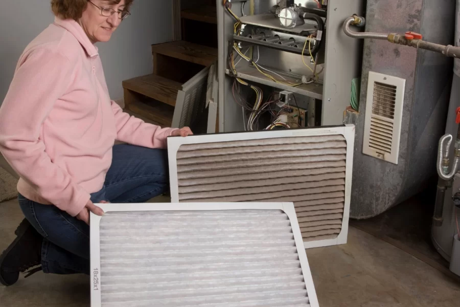 a-woman-replacing-air-filter-for-an-HVAC-system