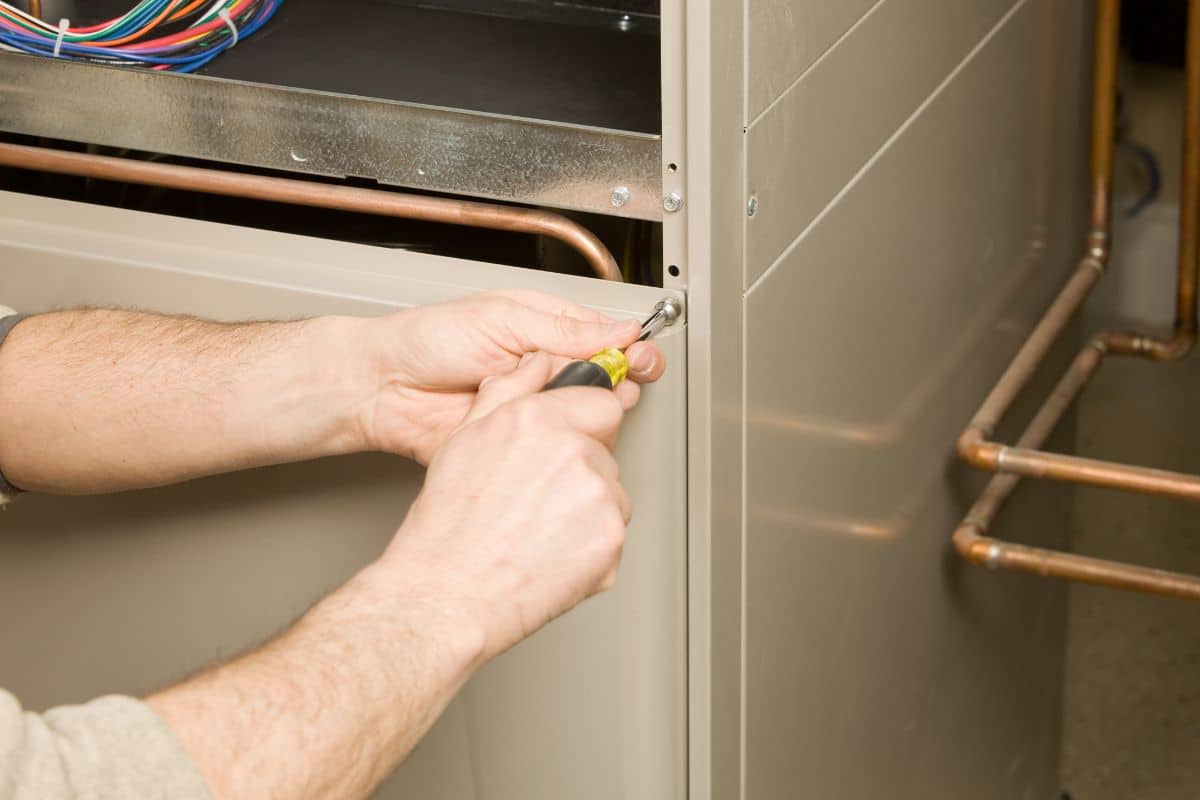 a man opening a furnace.