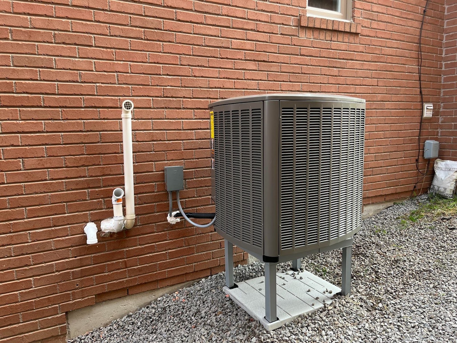 A heat pump outside of a house.