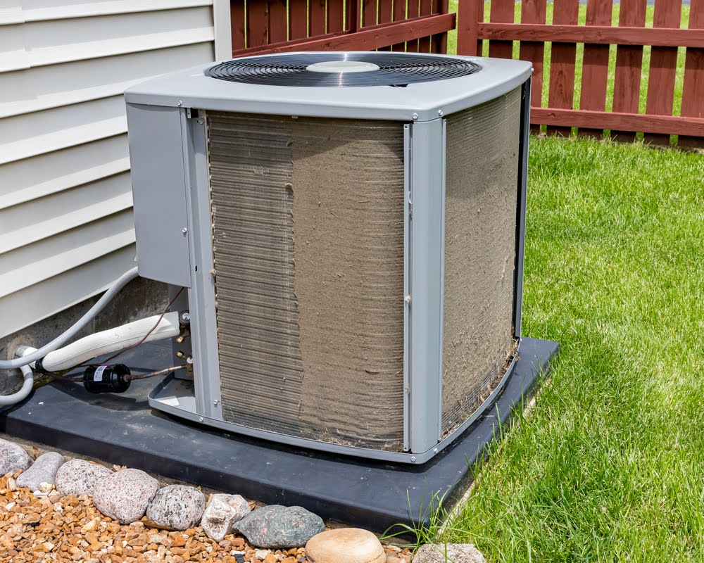 A dirty outdoor AC unit that needs cleaning.