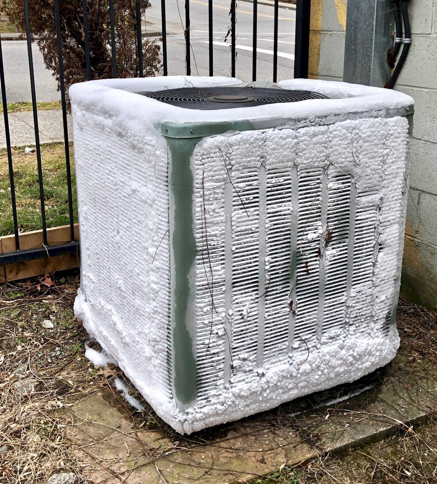 An outside AC unit with ice buildups.